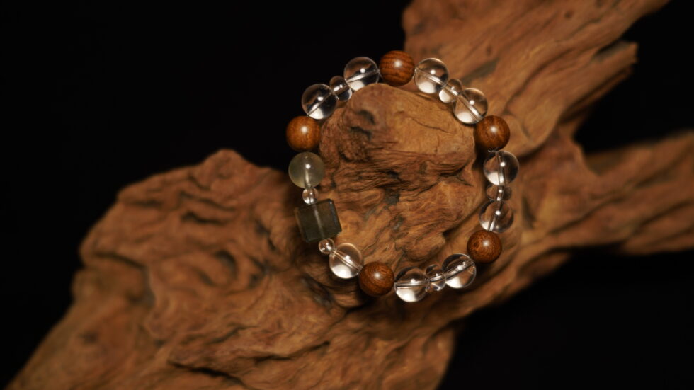 Minimalist crystal and peach wood bracelet on wrist